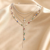 Parure di collana e orecchini in oro bianco con pietre multicolori