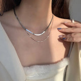 Collana a strati con serpenti in oro bianco