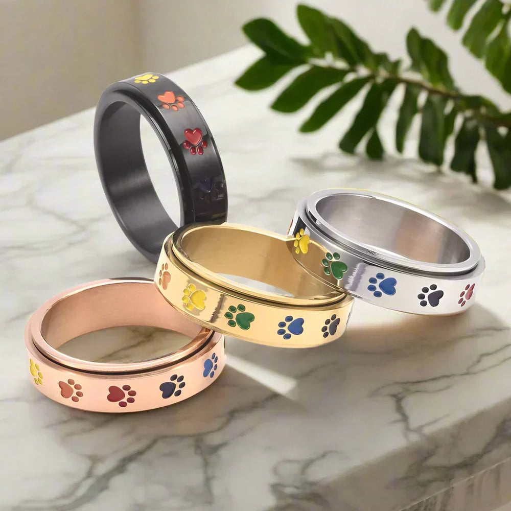 Anillo giratorio para aliviar el estrés: acero inoxidable con patas de arcoíris